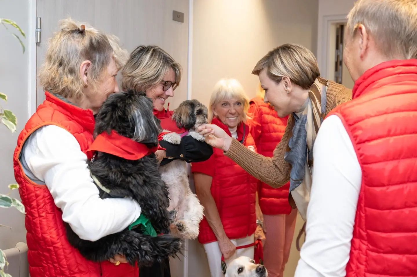 Die Fürstin von Monaco besucht ältere Menschen mit Hunden